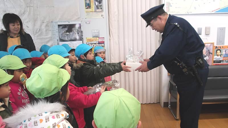 child gives a gift to a worker for Thanksgiving