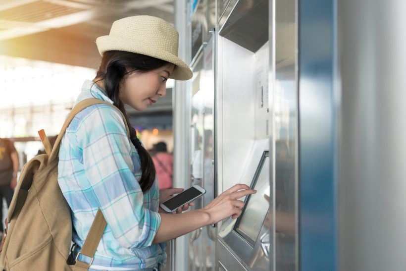 young woman with mobile in Japanese train station